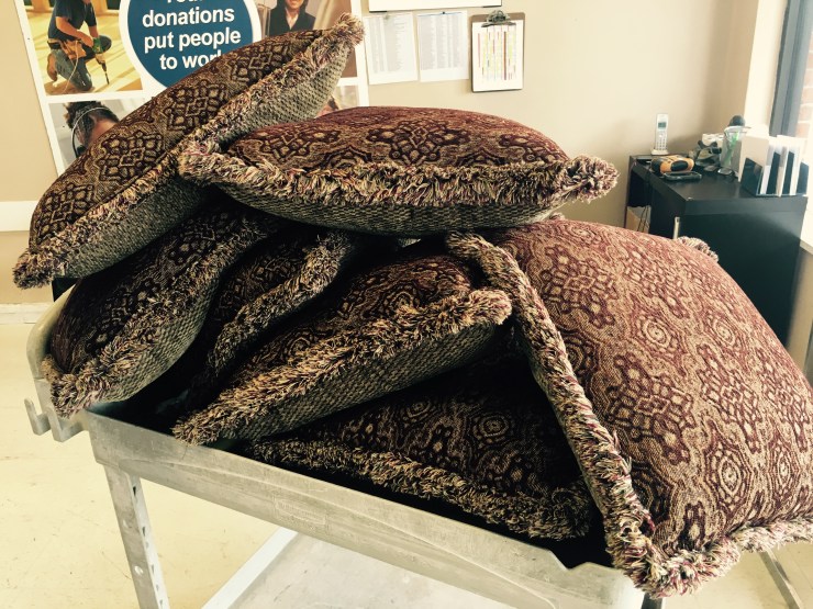 Seven throw pillow on a cart.