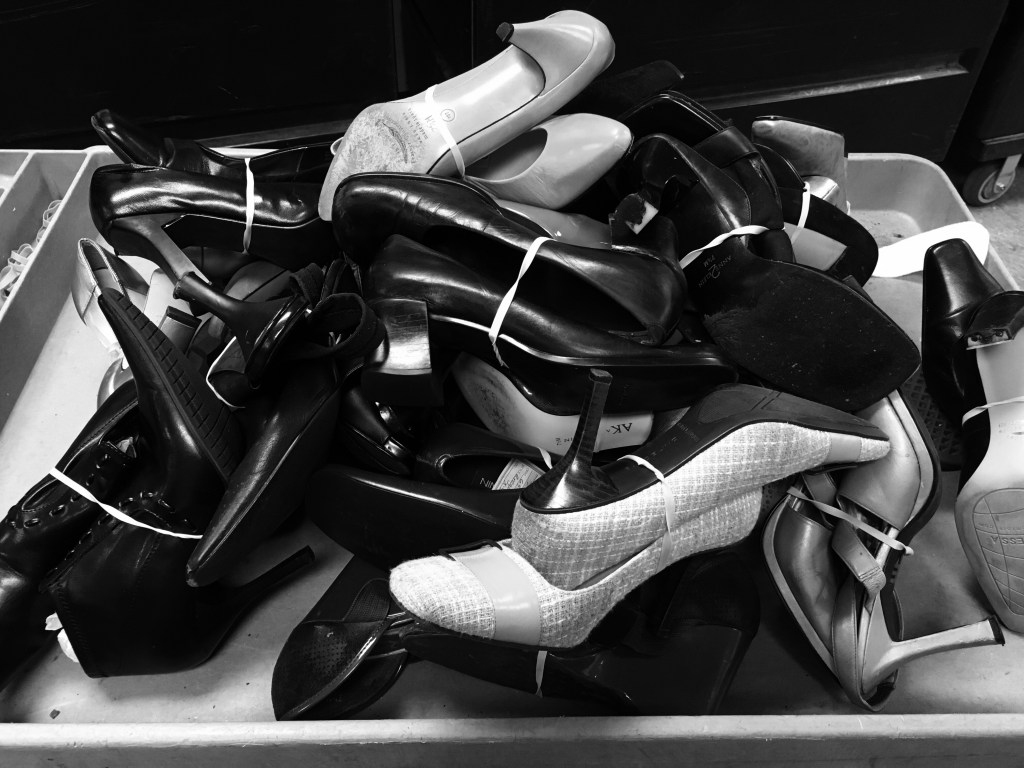 A cart filled with women's shoes.