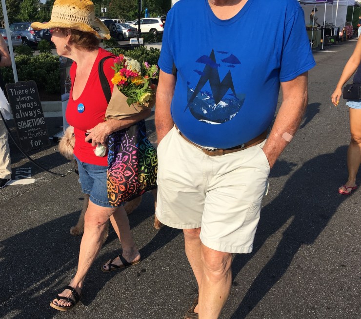 Woman carrying flowers.