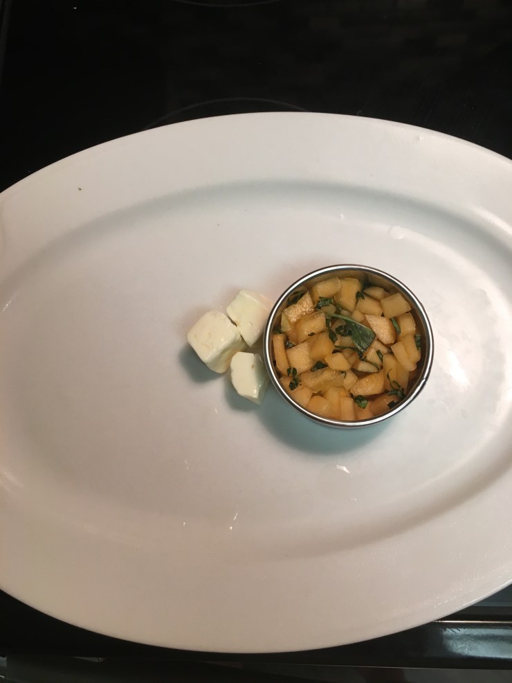 Feta cheese next to cantaloupe.