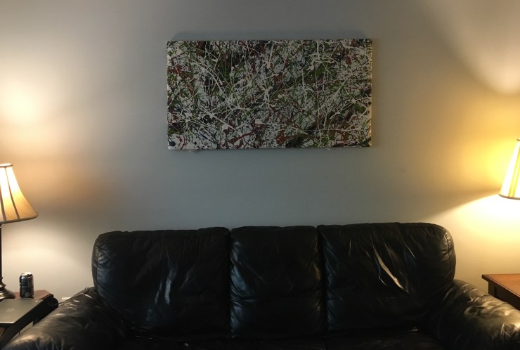 Action painting hanging in a living room.