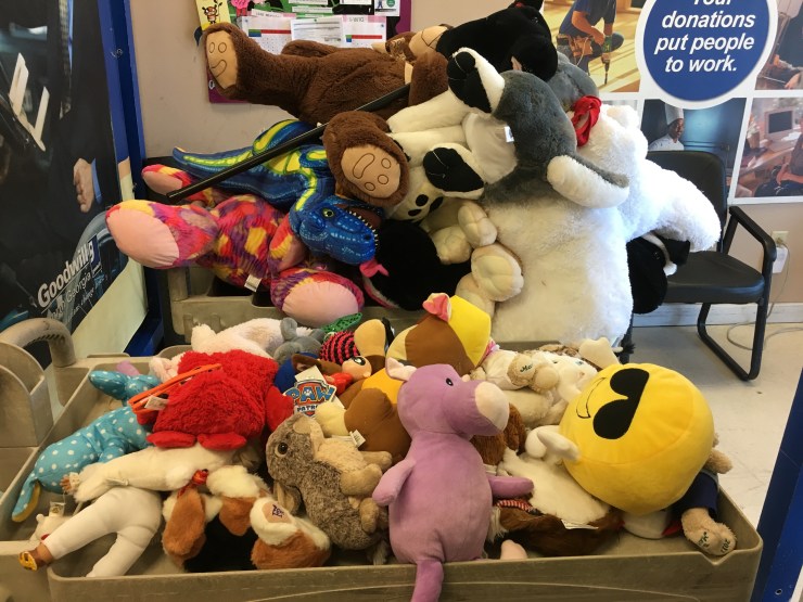 Stuffed animals on a cart.