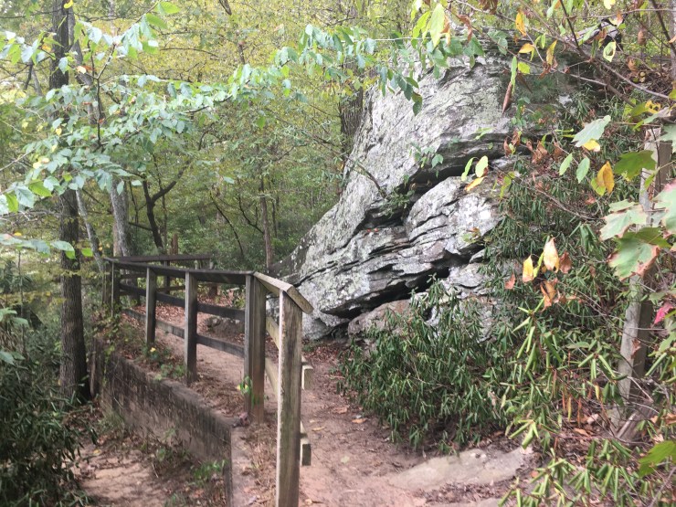 Handrail winding around a rock formation.