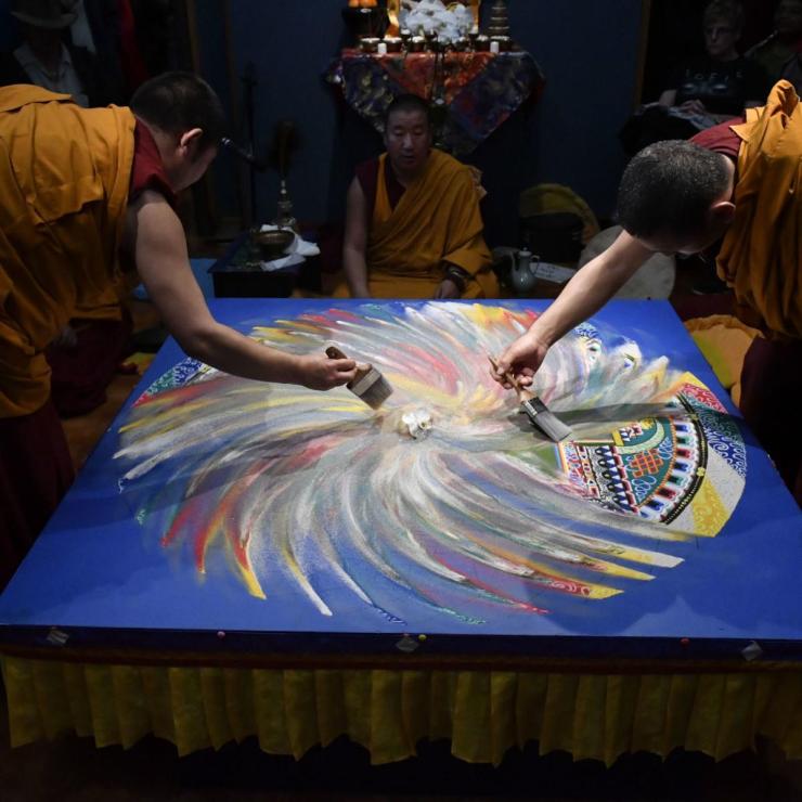 Monks erasing a mandala.