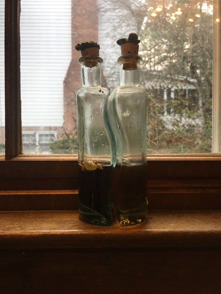Decorative bottles on a window sill.