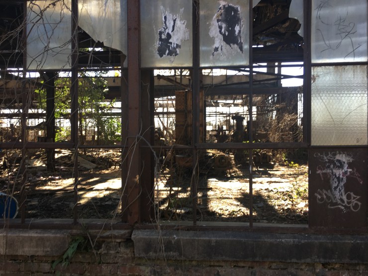 A gutted warehouse with broken windows.