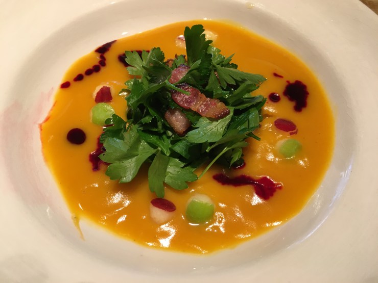 Butternut squash soup, parsley and bacon salad, apples and beet oil.