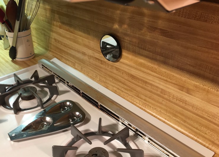 Mirror hanging over a stove.