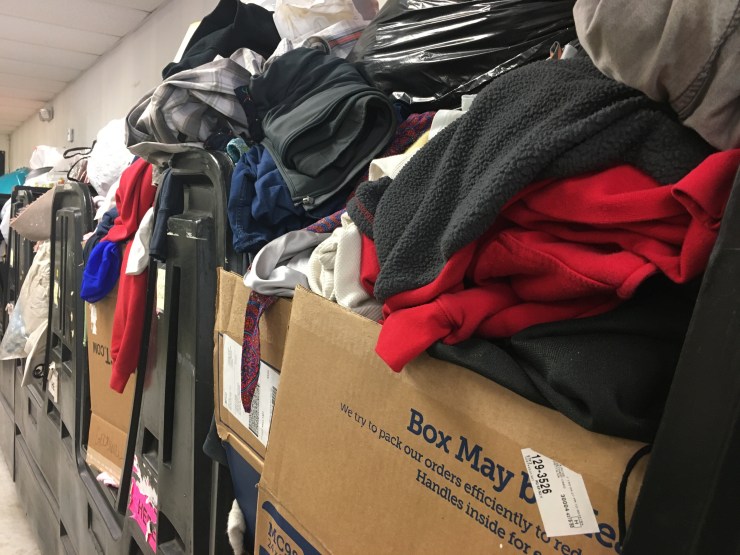 Large bins of unsorted clothes.