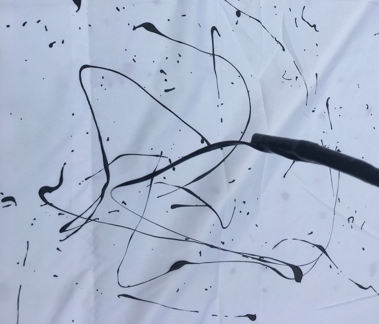 Paint dripping from a stick.