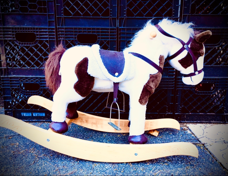 Rocking horse in front of milk crates