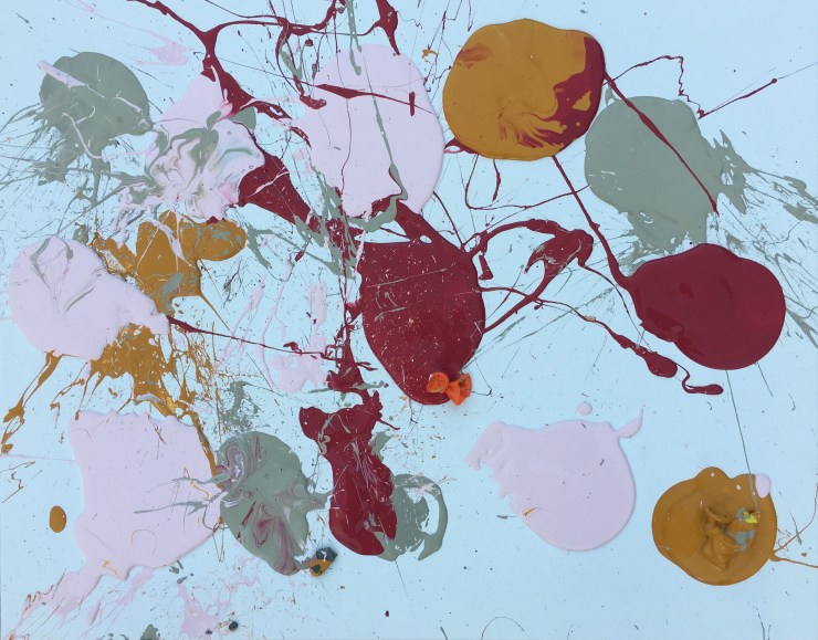 Balloons dipped in gray, pink, yellow and red paint, placed on a canvas and popped.
