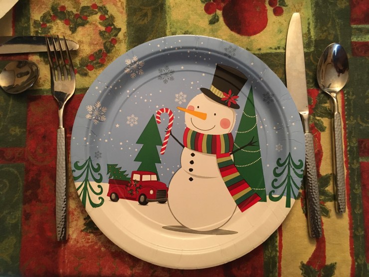 A paper plate with a snowman pattern.