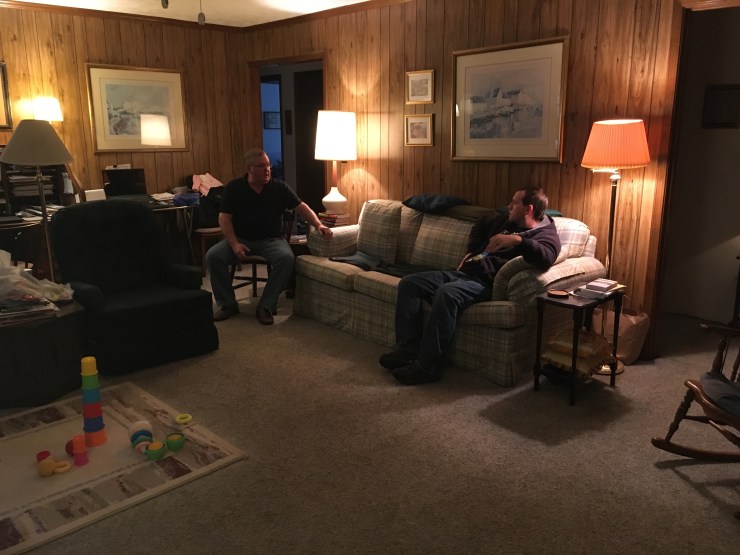 Two people chatting in a living room.