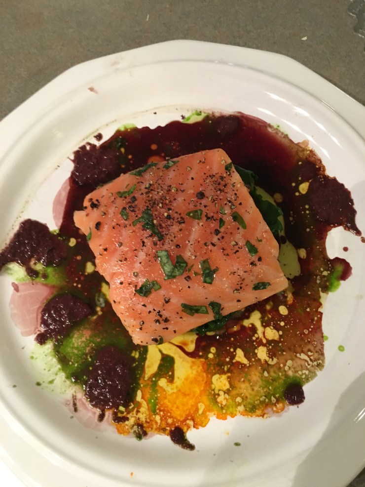 Salmon with red wine sauce, olive purée, parsley juice and saffron oil.