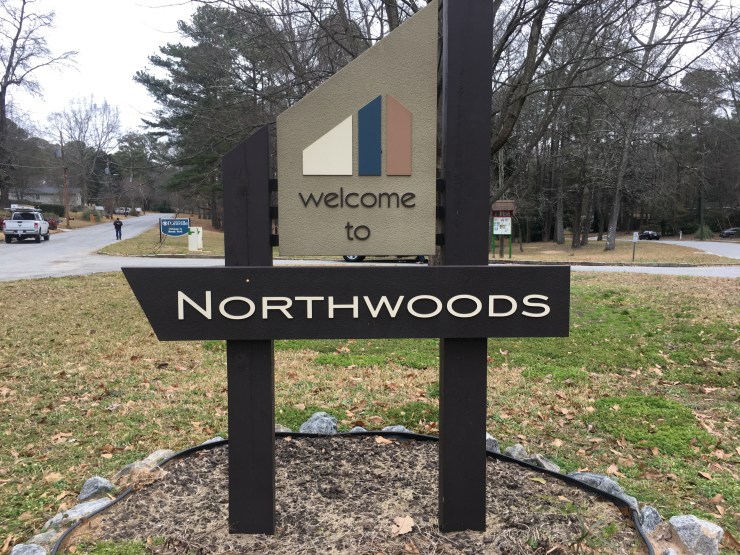 An entrance sign to the north woods neighborhood.