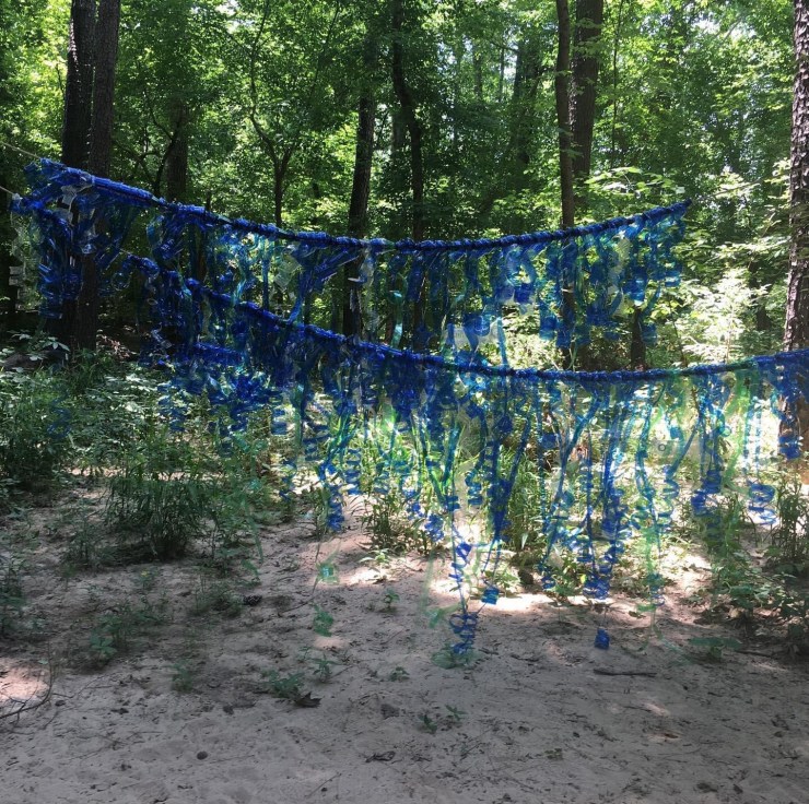 Blue streamers in front of a forest.