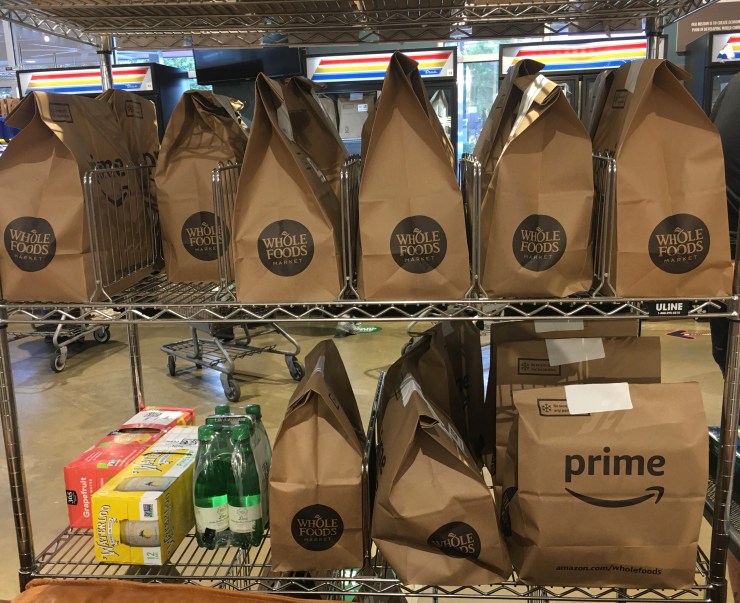 Amazon bags waiting on shelves for delivery.