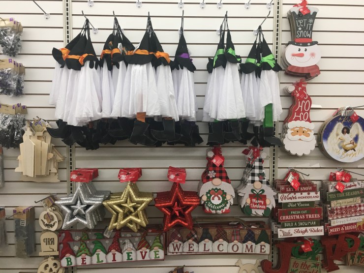 Halloween and Christmas decorations on the same shelf.