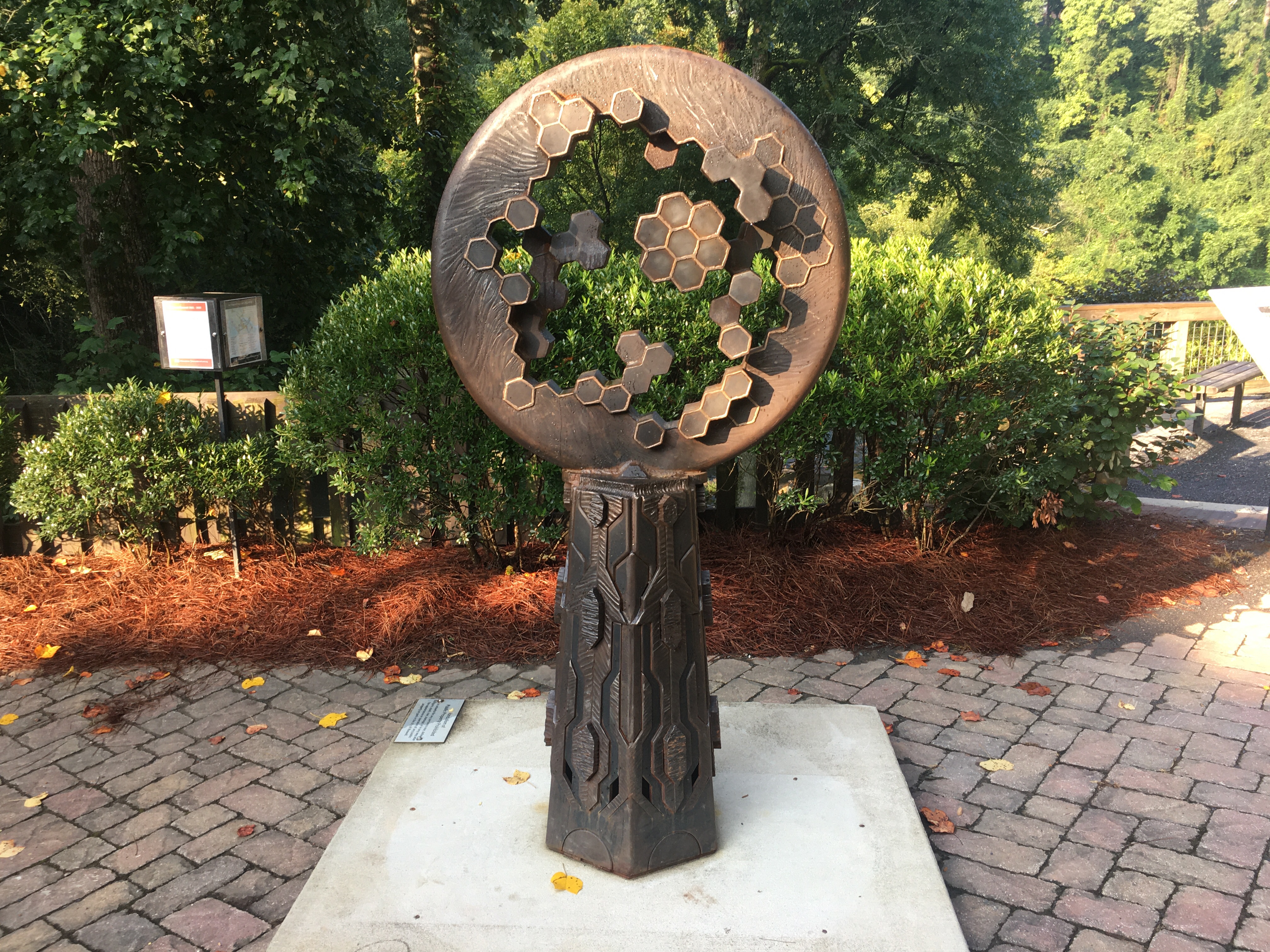 Statue of iron circle on a rusted base.