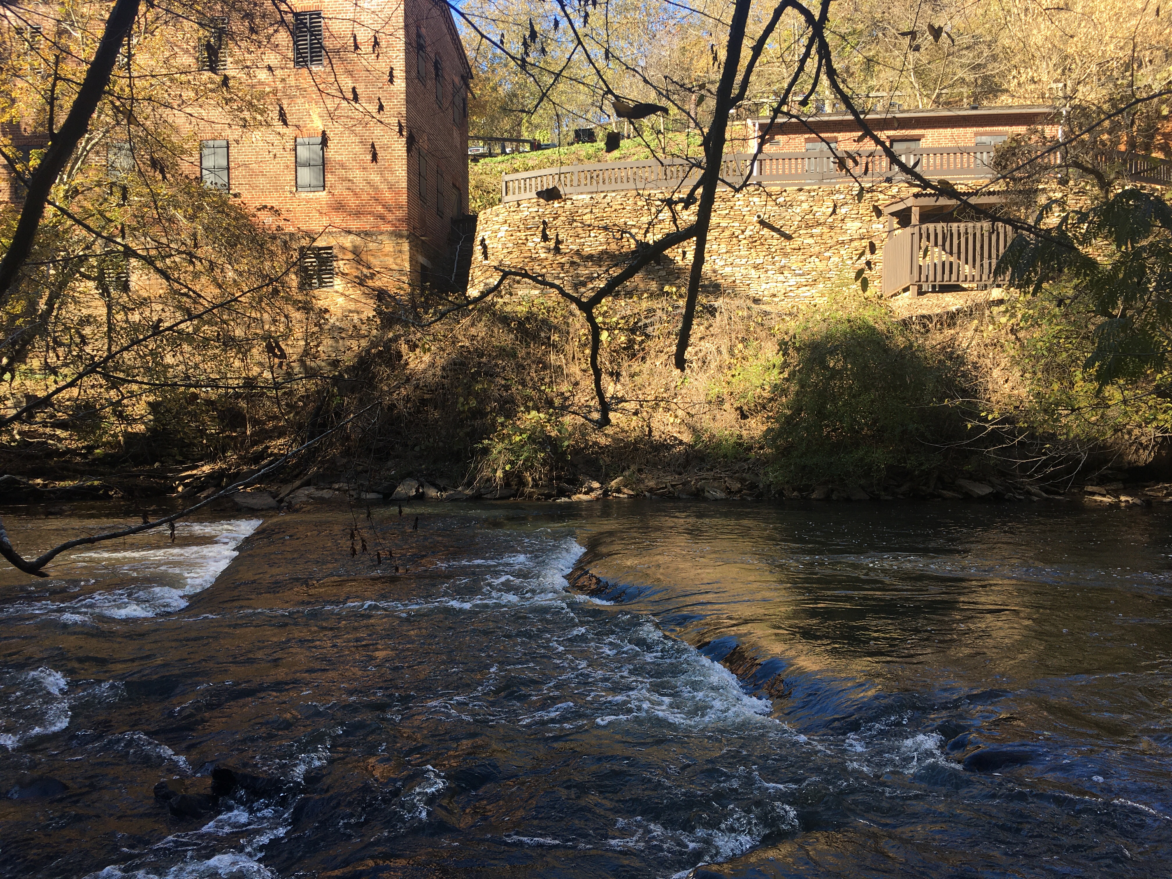 River flowing past old building.