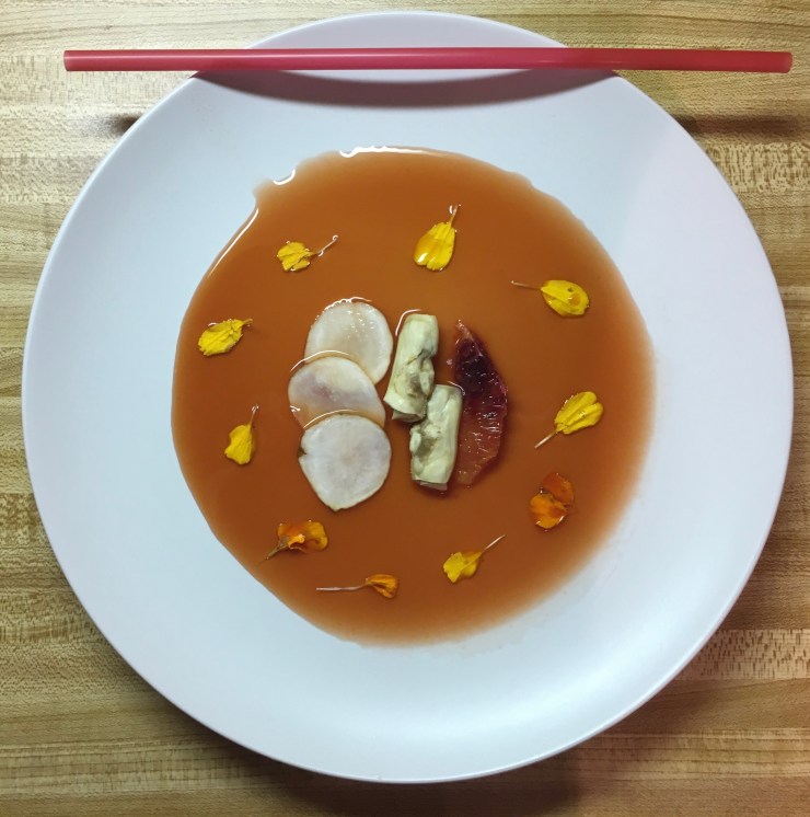 Razor clams, sunchokes and blood oranges with a drinking straw at the top of the plate.