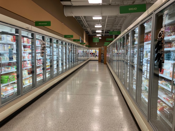 An empty frozen food aisle in a supermarket.